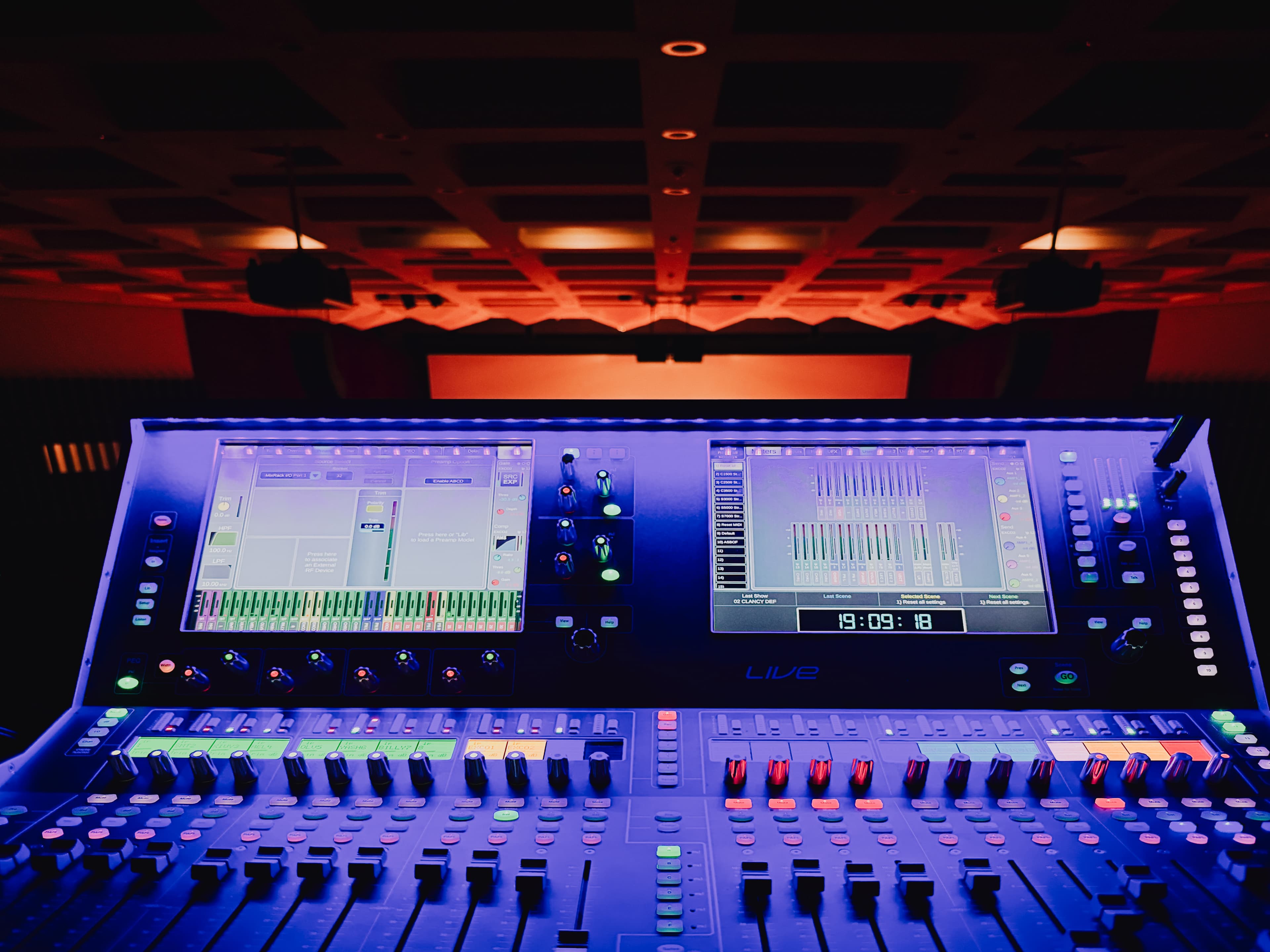 Audience and stage viewed through an event camera with room lighting in operation.